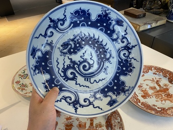 A Chinese blue and white 'dragon' dish and three iron-red and famille rose plates, 18th C.