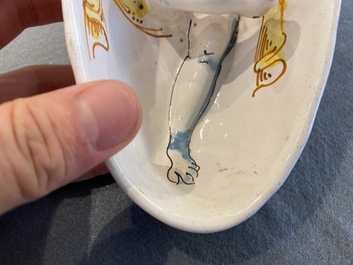 A polychrome French faience oval basin with a bathing woman, Nevers, 17th C.