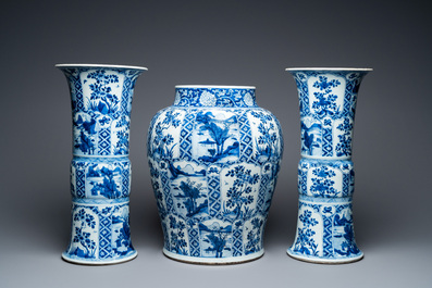 A large Chinese blue and white garniture of three vases, Kangxi