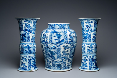 A large Chinese blue and white garniture of three vases, Kangxi