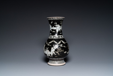 A Chinese famille noire vase with grisaille and iron-red design, 19th C.