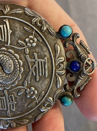 A Chinese reticulated jade 'three peacocks' carving in silver pendant, Qing