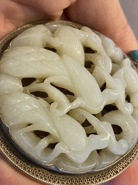 A Chinese reticulated jade 'three peacocks' carving in silver pendant, Qing