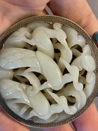 A Chinese reticulated jade 'three peacocks' carving in silver pendant, Qing