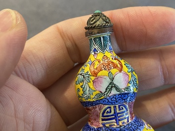 A Chinese Canton enamel snuff bottle and a pair of bone snuff bottles, 19th C.