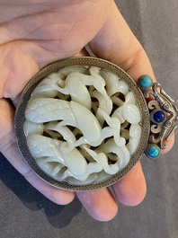 A Chinese reticulated jade 'three peacocks' carving in silver pendant, Qing
