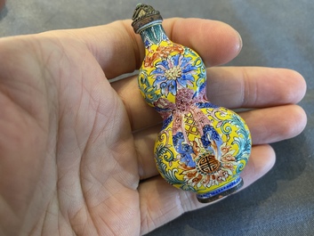 A Chinese Canton enamel snuff bottle and a pair of bone snuff bottles, 19th C.
