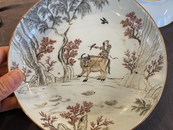 A pair of Chinese iron-red and grisaille 'boy on buffalo' plates, Qianlong