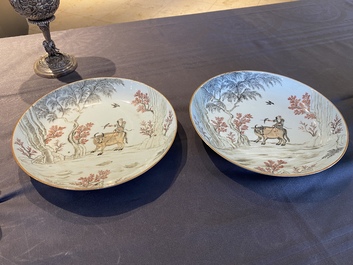A pair of Chinese iron-red and grisaille 'boy on buffalo' plates, Qianlong