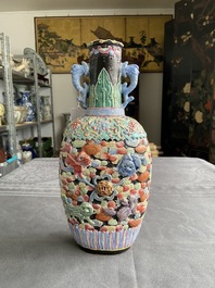 A Chinese famille rose vase with molded design of Buddhist lions, Qianlong mark, 19th C.