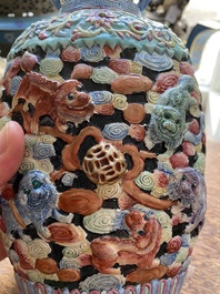 A Chinese famille rose vase with molded design of Buddhist lions, Qianlong mark, 19th C.