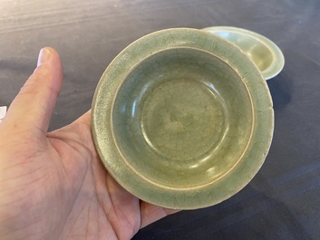 Two Chinese celadon-glazed bowls, one with twin fish, Ming