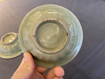 Two Chinese celadon-glazed bowls, one with twin fish, Ming