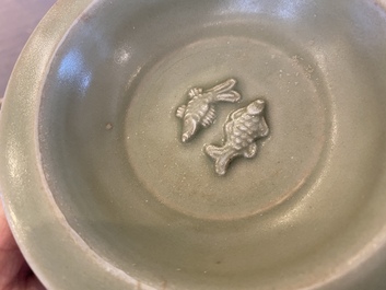 Two Chinese celadon-glazed bowls, one with twin fish, Ming