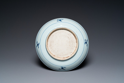 A Chinese blue and white 'dragon' dish and three iron-red and famille rose plates, 18th C.
