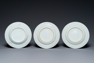 A Chinese blue and white 'dragon' dish and three iron-red and famille rose plates, 18th C.