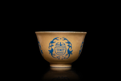 A Chinese blue enamel on gilt &lsquo;Shou&rsquo; tea bowl, 18/19th C.