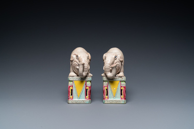 A pair of Chinese famille rose elephants on stands, 20th C.