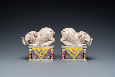 A pair of Chinese famille rose elephants on stands, 20th C.