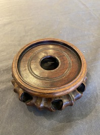 A Chinese famille verte rouleau vase on wooden 'lotus' stand, probably 19th C.