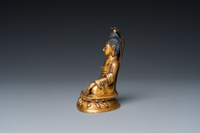 A small Sino-Tibetan gilt bronze Buddha, 19th C.