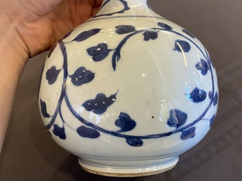 A pair of Chinese blue and white 'peony scroll' pharmacy bottles, Kangxi