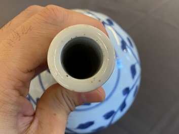 A pair of Chinese blue and white 'peony scroll' pharmacy bottles, Kangxi