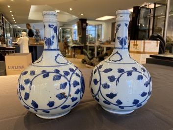 A pair of Chinese blue and white 'peony scroll' pharmacy bottles, Kangxi