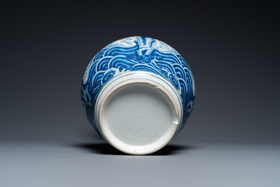 A Chinese blue and white vase with rocks in a wavy sea, Qianlong/Jiaqing