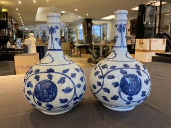 A pair of Chinese blue and white 'peony scroll' pharmacy bottles, Kangxi