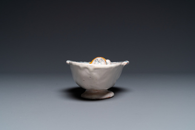 A polychrome French faience oval basin with a bathing woman, Nevers, 17th C.