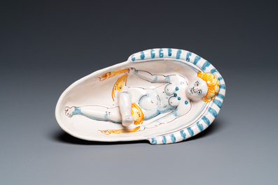 A polychrome French faience oval basin with a bathing woman, Nevers, 17th C.