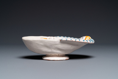 A polychrome French faience oval basin with a bathing woman, Nevers, 17th C.