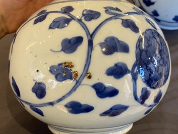 A pair of Chinese blue and white 'peony scroll' pharmacy bottles, Kangxi