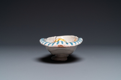 A polychrome French faience oval basin with a bathing woman, Nevers, 17th C.