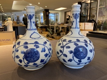 A pair of Chinese blue and white 'peony scroll' pharmacy bottles, Kangxi