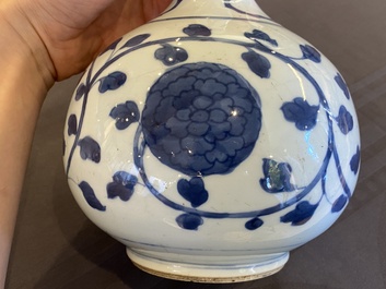 A pair of Chinese blue and white 'peony scroll' pharmacy bottles, Kangxi