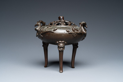 A Chinese bronze tripod censer and cover, 19th C.