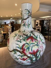 A Chinese famille rose 'nine peaches' bottle vase, Qianlong mark, 19th C.
