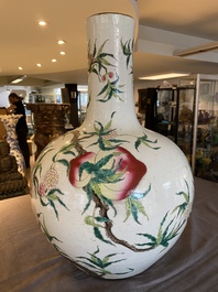 A Chinese famille rose 'nine peaches' bottle vase, Qianlong mark, 19th C.
