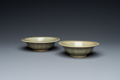 Two Chinese celadon-glazed bowls, one with twin fish, Ming