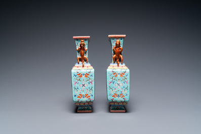 A pair of Chinese famille rose turquoise-ground vases, Qianlong mark, 19/20th C.