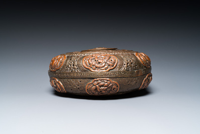 A Tibetan pierced and repouss&eacute; copper scent box and cover with inscribed mantra, 18/19th C.