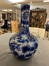 A Chinese blue and white 'dragons' bottle vase, 19th C.