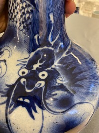 A Chinese blue and white 'dragons' bottle vase, 19th C.