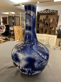 A Chinese blue and white 'dragons' bottle vase, 19th C.