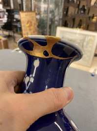 Two Chinese blue and white 'prunus' vases with kintsugi repairs, Qianlong mark, 20th C.