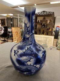 A Chinese blue and white 'dragons' bottle vase, 19th C.