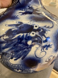 A Chinese blue and white 'dragons' bottle vase, 19th C.