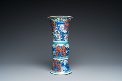 A Chinese blue and white 'gu' vase with European clobbered design, Kangxi